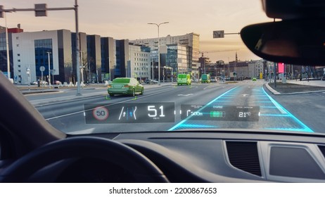 Futuristic Autonomous Self-Driving Car Moving Through City, Head-up Display Showing Infographics: Speed, Distance, Navigation. Road Scanning. Driver Seat Point Of View POV Or First Person View FPV