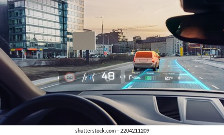 Futuristic Autonomous Self-Driving Car Moving Through City, Head-up Display Showing Infographics: Speed, Distance, Navigation. Road Scanning Concept. Driver Seat POV  First Person View FPV