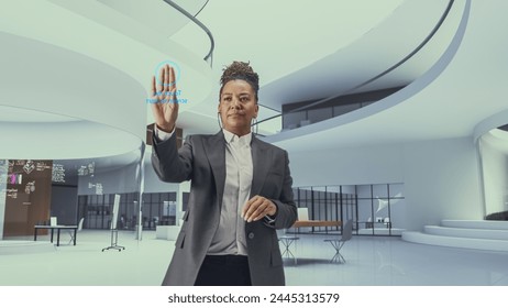 Futuristic Black Business Leader Businesswoman Standing in a Virtual Space, Gesturing with an Augmented Reality Hologram Analysing Big Data, Financial Reports, Stock Market Statistics, Infographics - Powered by Shutterstock