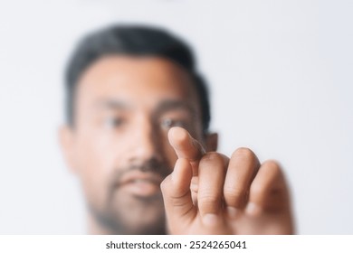 Futuristic businessman pressing his finger on invisible screen, Front view of a man touching screen in digital and technology concept. Businessman touching futuristic screen with future technology - Powered by Shutterstock