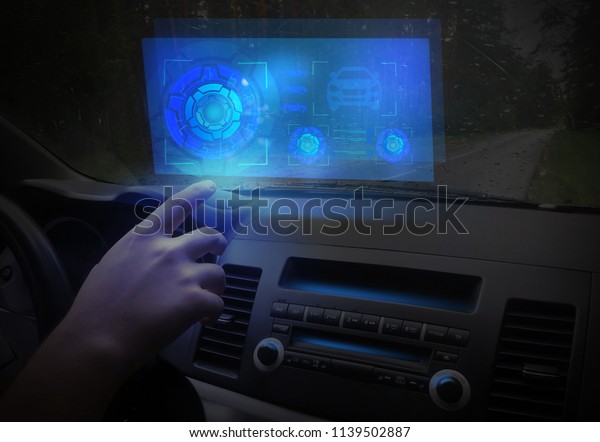 Futuristic car cockpit and touch screen.\
Autonomous car. Driverless vehicle. HUD(Head up display).\
GUI(Graphical User Interface). IoT(Internet of\
Things).