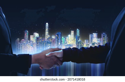 Futuristic city technology concept of businessman shaking hands on deal teamwork partnership, smart city internet of things blue background of internet network connection communication concept