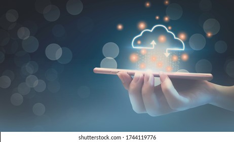 Futuristic cloud computing storage system concept,business woman hand holding smartphone,with interface cloud icon,connect to data base station and operations,use artificial intelligence or AI system.