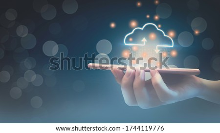 Futuristic cloud computing storage system concept,business woman hand holding smartphone,with interface cloud icon,connect to data base station and operations,use artificial intelligence or AI system.