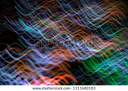 Futuristic colorful curvy thin line light trails with dark background. Abstract Data Communication concept.