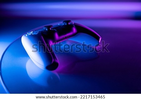 
futuristic concept abstract gamepad in neon vibrant purple and blue light. place for text. copy space