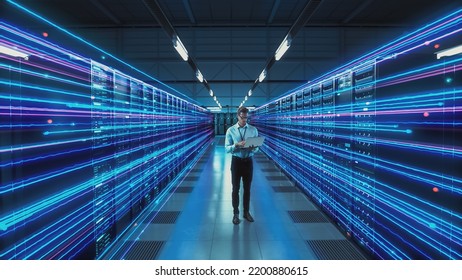 Futuristic Concept: Data Center Chief Technology Officer Holding Laptop, Standing In Warehouse, Information Digitalization Lines Streaming Through Servers. SAAS, Cloud Storage, Online Service - Shutterstock ID 2200880615