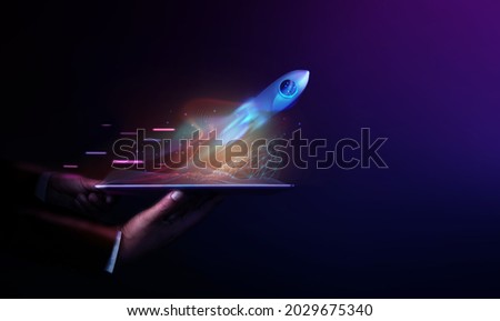 Futuristic Conceptual Photo. Startup Concept. Rocket Take-off  and Released from Digital Tablet to Space. Mission to Moon. Symbol of Success