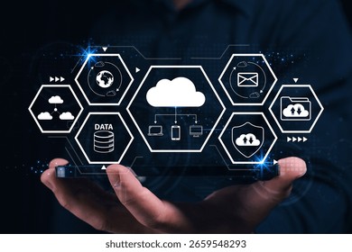 A futuristic digital interface showing cloud computing and data management icons above a person's hand holding a tablet.