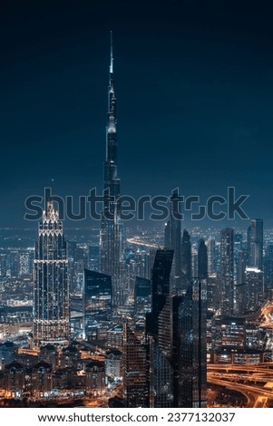 Futuristic Dubai cityscape including the iconic Burj Khalifa illuminated at night in Dubai, United Arab Emirates (UAE).
