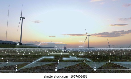 Futuristic Engineer Working On Wind Farm On Sunset Using Nano Technology With 3d Model Construction Of Windmill Buildings. Agronomy Business. Tech Innovation. Hi-tech Concept. Human Future. 