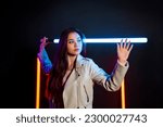 Futuristic game atmosphere with pretty asian woman holding lightsaber in neon lights.