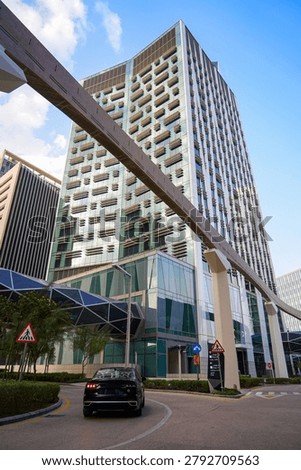 Futuristic geometric skyscraper, skybridge and elevated transit rail track at King Abdullah Financial District KAFD, Riyadh, Saudi Arabia