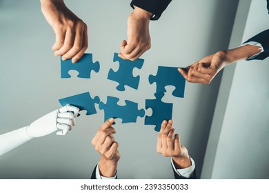 Futuristic HR recruitment with productive automation working in panoramic banner, as AI or artificial intelligence robotic workforce displace human. Robotic hand hold puzzle piece to fill gap. Shrewd - Powered by Shutterstock