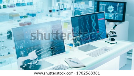 Futuristic laboratory equipment - coronavirus testing. Computer screens in laboratory. DNA models and coronavirus research