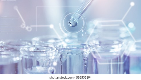 In a futuristic laboratory, a scientist with a pipette analyzes a colored liquid to extract the DNA and molecules in the test tubes.Concept:research,biochemistry,immersive technology,augmented reality - Shutterstock ID 586533194
