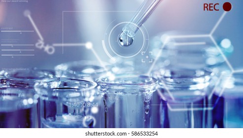 In a futuristic laboratory, a scientist with a pipette analyzes a colored liquid to extract the DNA and molecules in the test tubes.Concept:research,biochemistry,immersive technology,augmented reality