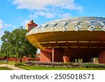 Futuristic Lloyd Wright Dome and Brick Tower in Urban Park Eye-Level Perspective