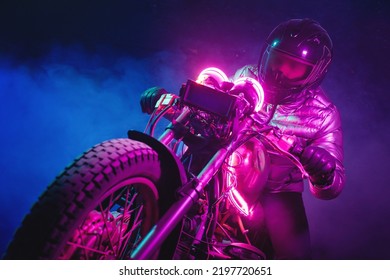 A futuristic motorbiker on the neon light motorcycle close up. - Shutterstock ID 2197720651