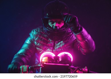 A futuristic motorbiker on the neon light motorcycle close up. - Shutterstock ID 2197720659