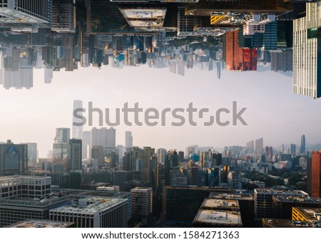 Futuristic multiverse world concept. Downtown with skyscrapers skyline under and cityscape over. Two parallel worlds. Alternative reality dimension