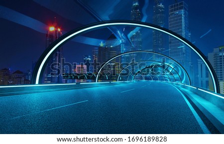 Futuristic neon light and glass facade design of tunnel flyover road with night cityscape background . Mixed media .