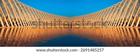 Futuristic olimpic complex in Athens with reflections in the lake at sunset