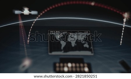 Futuristic operations room visualizes satellite paths, interception arcs and a world map during a fictional global defense simulation.