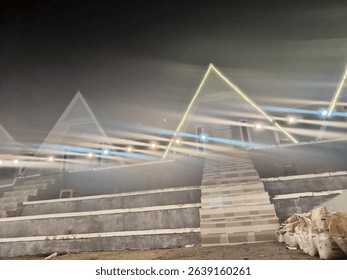 Futuristic outdoor space with neon triangular lights and string lights illuminating concrete steps at night, creating a unique, modern ambiance.
