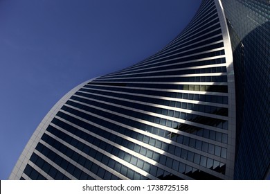 Futuristic part of skyscrapers design on clear blue sky background. Abstract facade design. Glass and metal in modern city architecture. Modern buildings exterior. Construction industry. Abstraction.