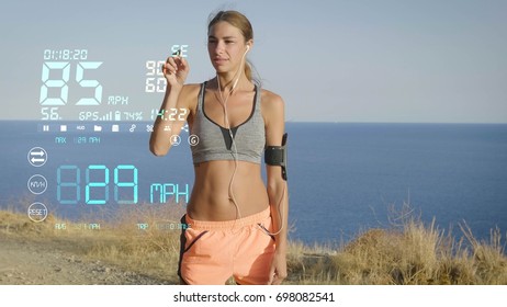 A futuristic portrait of a sportswoman, uses a digital hologram rhythm of speed and movement in the phone, the background of the sea. Concept: future technologies, love sports, jogging, sportswear. - Powered by Shutterstock