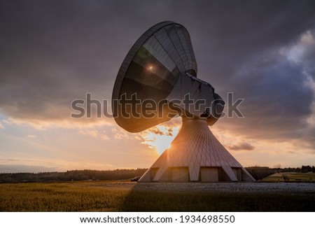 Futuristic satelite dishes at sunset
