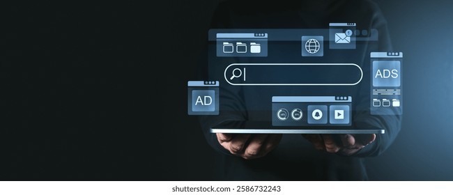 Futuristic search engine interface icons hovering over a tablet against a dark background. Concept of online technology and internet browsing