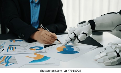 A futuristic setting where a robot collaborates with a human, showcasing charts and graphs. This image represents the blending of technology with human creativity in the workplace.Noogenesis - Powered by Shutterstock - Get 15% off with code: PIKWIZARD15