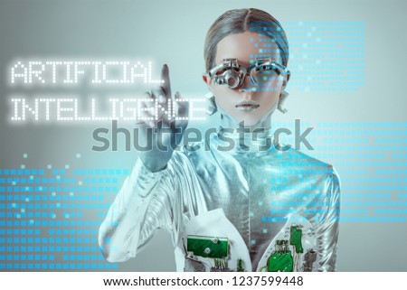 futuristic silver cyborg touching 