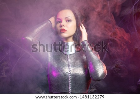 futuristic Space fashion person in silver stylish outfit in the smoke