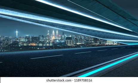 Futuristic style highway road with blue neon light and cityscape background .