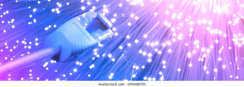 Futuristic technological background, closeup on the end of optical fiber network cable on blue background