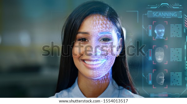 Futuristic and technological scanning of the face of a
beautiful woman for facial recognition and scanning to ensure
personal safety. 