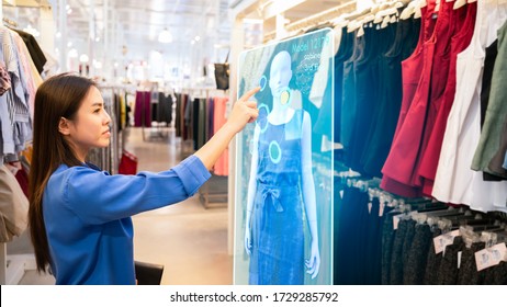 Futuristic Technology Concept.happy Girl Try To Use Smart Hologram Display With Virtual Augmented Reality In The Shop Or Retail To Choose Select ,buy Clothes And Change A Color Of Products.