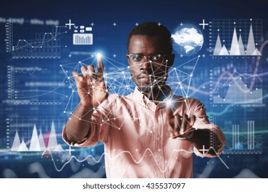 Futuristic Technology. Double Exposure. Portrait Of African Employee In Glasses, Looking At The Camera With Serious Concentrated Expression, Touching Screen Interface Against High-tech Interior