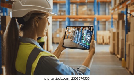 Futuristic Technology Warehouse Concept: Female Worker Doing Inventory, Using Augmented Reality Application On Tablet. Woman Analyzes Digitalized Products Delivery Infographics in Distribution Center. - Powered by Shutterstock