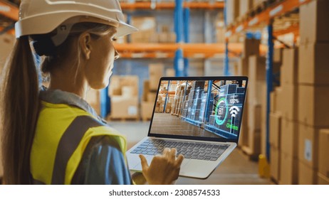 Futuristic Technology Warehouse: Female Worker Doing Inventory, Using Augmented Reality Program On Laptop Computer. Woman Analyzes Digitalized Products Delivery Infographics in Distribution Center. - Powered by Shutterstock