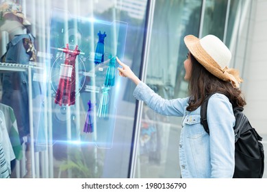 futuristic technology,smart retail online concept.Woman try to use  hologram display with virtual augmented reality in the shop or retail to choose select ,buy cloths and change a color of products