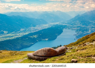 A futuristic wooden bench with a beautiful panoramic view of the Drava River valley and Lake Millstatt, Nock mountains, Gurktal Alps, Austria.