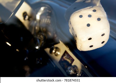 Fuzzy Dice Dangling From Classic Car Rearview Mirror With Dashboard