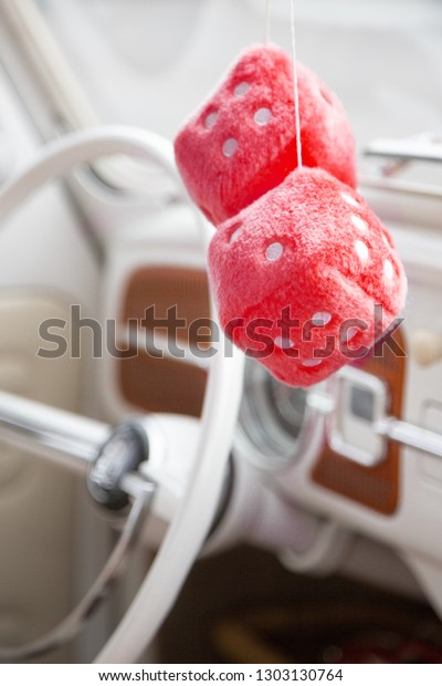 fuzzy dice\
hanging from mirror in front car\
seat