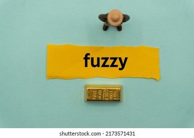 fuzzy.The word is written on a slip of paper,on colored background. professional terms of finance, business words, economic phrases. concept of economy.