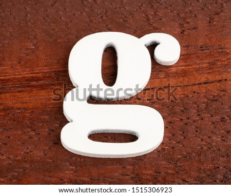 g - lowercase letter. Piece in wood