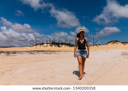 Gabi posing for photos in Natal with the Genipabu Dunes background.